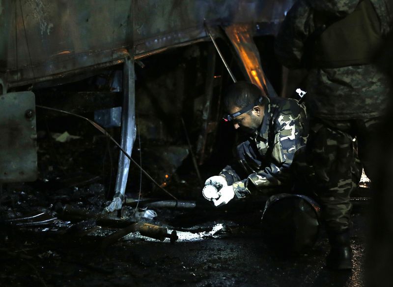 © Reuters. Afghan security forces inspect at the site of a suicide attack in Kabul