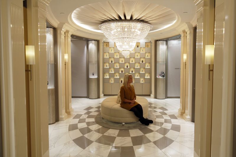 © Reuters. An employee poses in the Salon de Parfums in Harrods, London