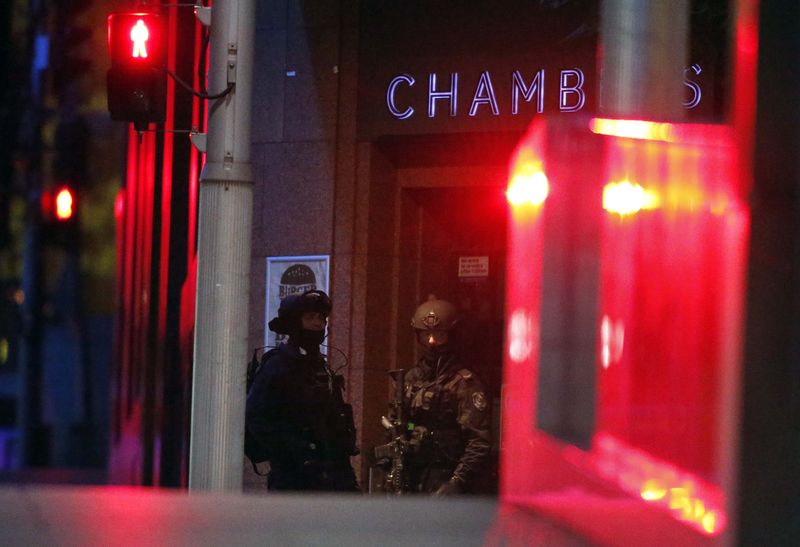 © Reuters. Policiais do lado de fora de cafeteria em Sydney onde homem armado mantinha reféns