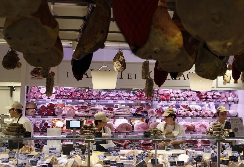 © Reuters. Employees work at the butchery work bench during the opening day of upmarket Italian food hall chain Eataly's flagship store in downtown Milan