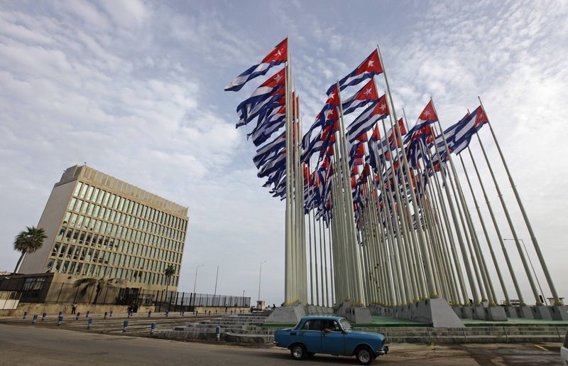 © Reuters. File picture shows a car driving past the building of the the U.S. diplomatic mission in Cuba, The U.S. Interests Section, (USINT), in Havana