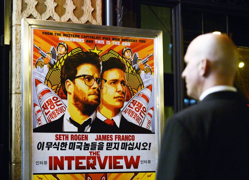 © Reuters. File photo of a security guard standing at the entrance of United Artists theater during the premiere of the film "The Interview" in Los Angeles