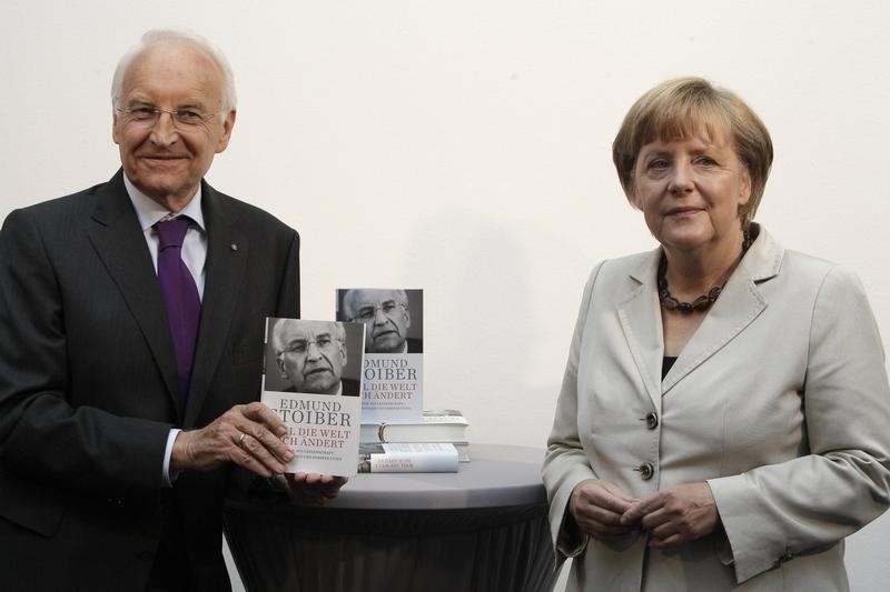 © Reuters. German Chancellor Merkel and former Bavarian State Premier Stoiber attend book presentation in Berlin