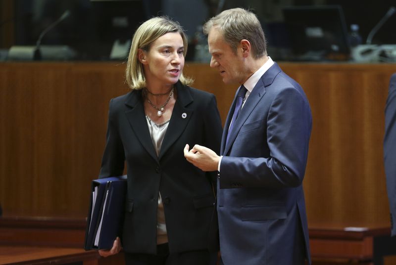 © Reuters. EU foreign policy chief Mogherini talks to EU Council President Tusk during an EU leaders summit in Brussels