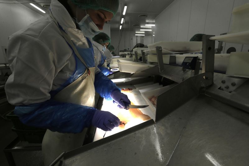 © Reuters. eople work in a Viciunai Group fish factory in Kaunas