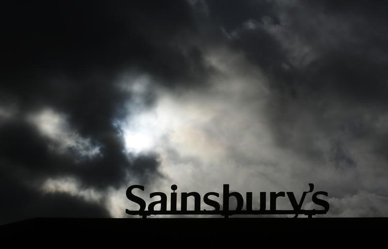© Reuters. A Sainsbury's sign is seen silhouetted outside a supermarket at Pulborough, southern England