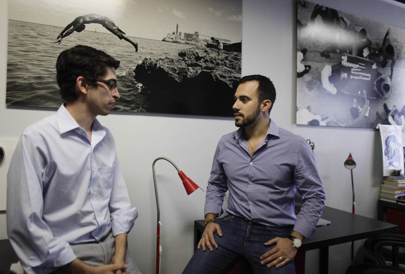 © Reuters.  Moas and Gorordo speak in their office in Miami Beach