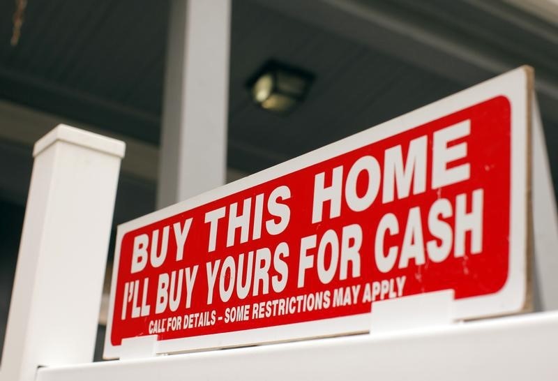 © Reuters. The sign on a property for sale in Somerville reads "Buy This Home I'll Buy Yours For Cash"