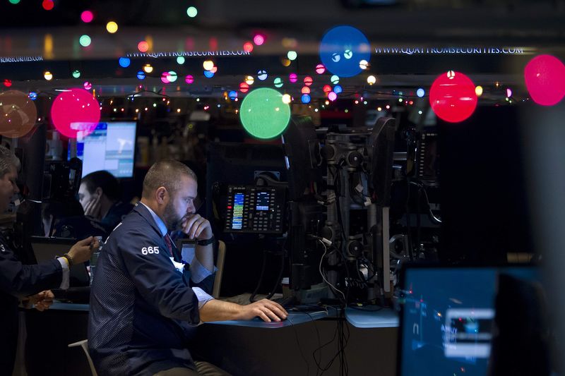 © Reuters. Trader Kevin Lodewick works on the floor of the NYSE, which has been decorated with Christmas lights, in New York