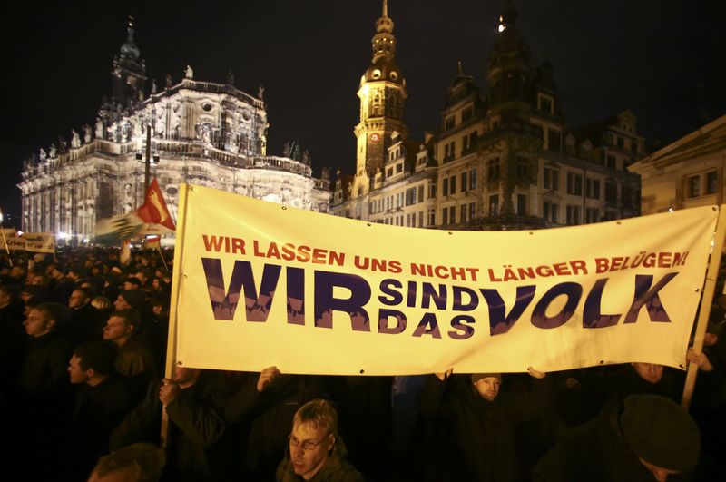 © Reuters. Participants hold a banner during a demonstration called by anti-immigration group PEGIDA, a German abbreviation for "Patriotic Europeans against the Islamization of the West", in Dresden