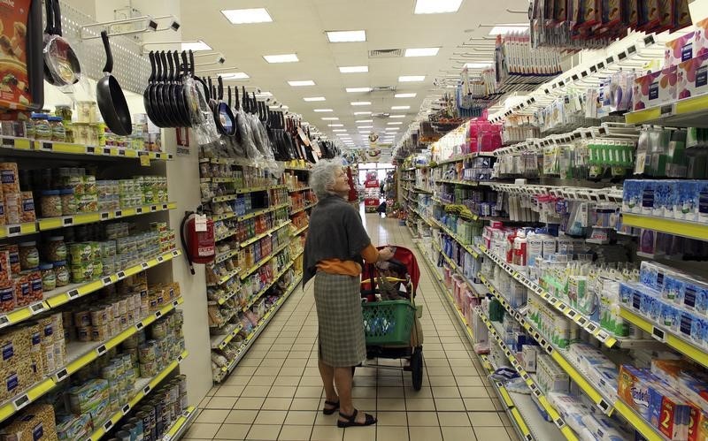 © Reuters. A woman shops at a supermarket in Milan