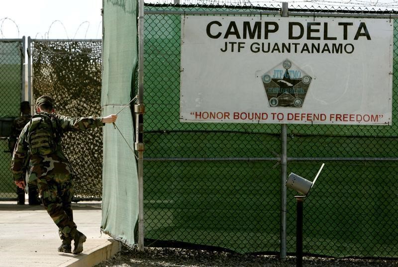 © Reuters. Soldier closes gate as military tribunals continue At Guantanamo.