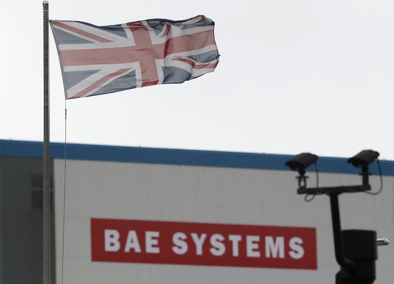 © Reuters. A union flag flies over the entrance to the naval dockyards, where BAE Systems are also located, in Portsmouth