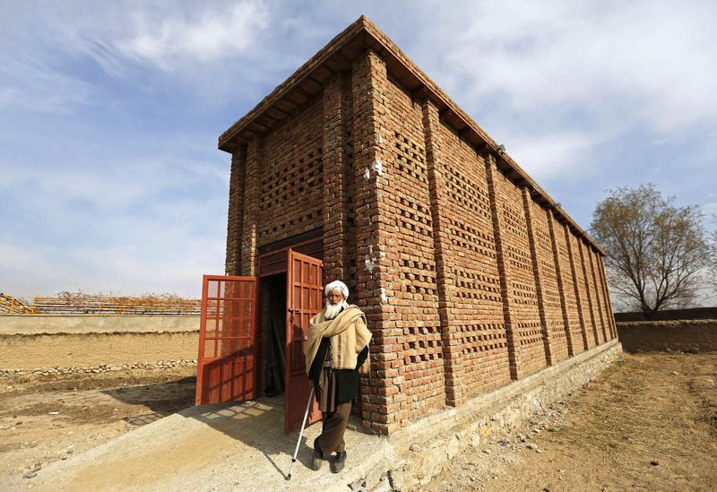 © Reuters. Afghan farmer Mohammad Malik stands outside his grape pitfall which was build by USAID project in Parwan