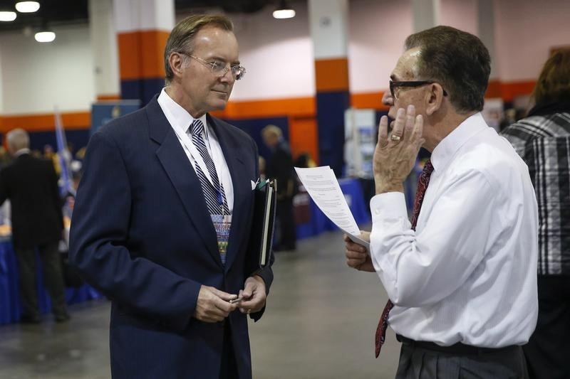 © Reuters. A man speaks with a job recruiter at the Nassau County Mega Job Fair at Nassau Veterans Memorial Coliseum in Uniondale, New York