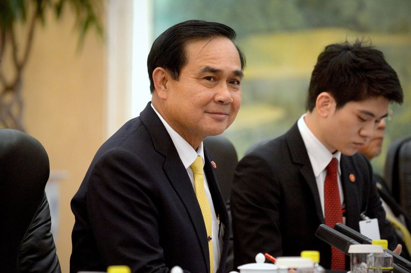 © Reuters. Thailand's Prime Minister Prayuth Chan-ocha listens as he meets with China's President Xi Jinping at the Great Hall of the People in Beijing