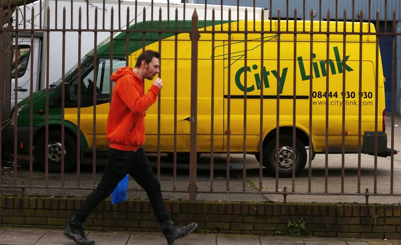 © Reuters. A man walks past a van standing idle at a City Link depot in south London