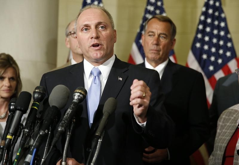 © Reuters. Newly elected House Majority Whip Scalise speaks to the media as Speaker of the House Boehner listens on Capitol Hill in Washington