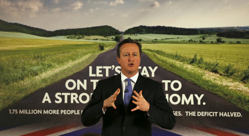 © Reuters. Britain's Prime Minister David Cameron speaks as he stands in front of a new Conservative Party poster after unveiling it in Halifax