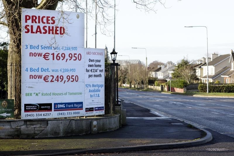 © Reuters. An advertising board is pictured in Longford town showing reduced prices on houses
