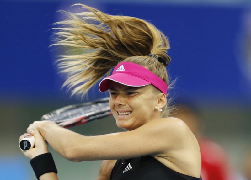 © Reuters. Daniela Hantuchova hits a return to Kirsten Flipkens during their match at IPTL in Dubai