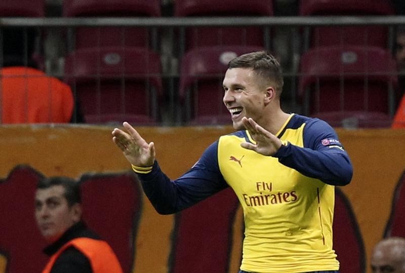 © Reuters. Podolski celebrates his second goal against Galatasaray during Champions League Group D soccer match at Ali Sami Yen Spor Kompleksi in Istanbul