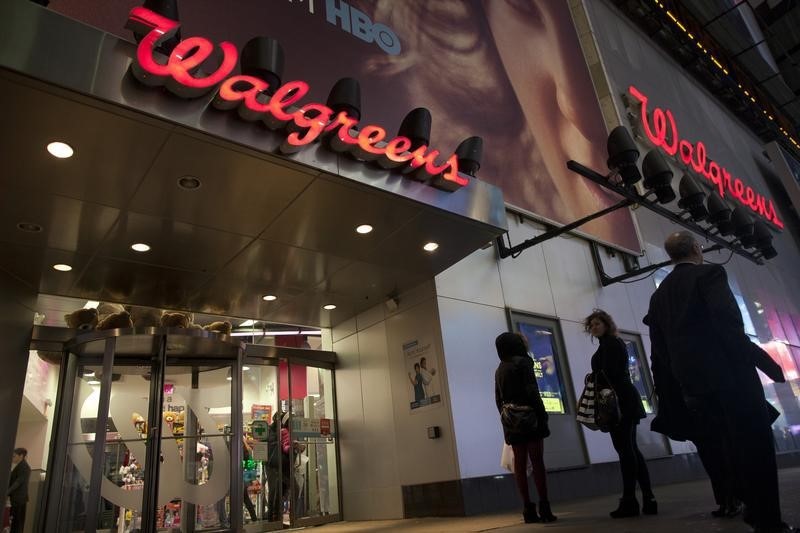 © Reuters. Shoppers walk by at the Walgreens' Times Square store in New York