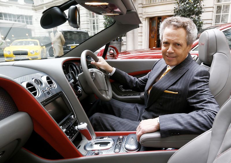© Reuters. Bentley Chief Executive Wolfgang Durheimer poses for a photograph at the wheel of a Bentley GTC Speed in the courtyard of a hotel in central London