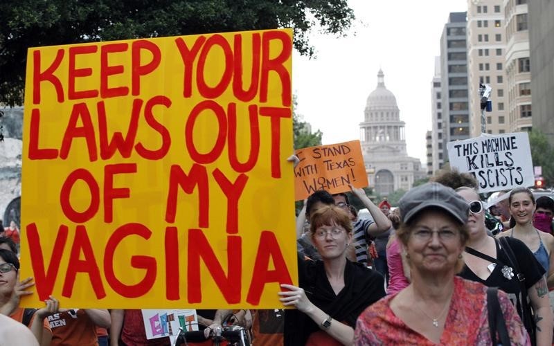 © Reuters. Minter carries a sign during an abortion rights march in Austin