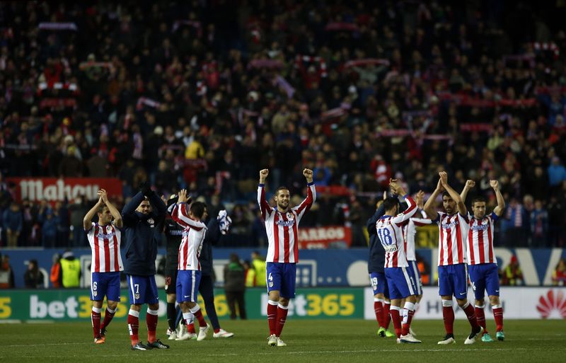 © Reuters. Atletico Madrid's players celebrates their victory over Real Madrid at the end of their Spanish King's Cup soccer match at Vicente Calderon stadium in Madrid