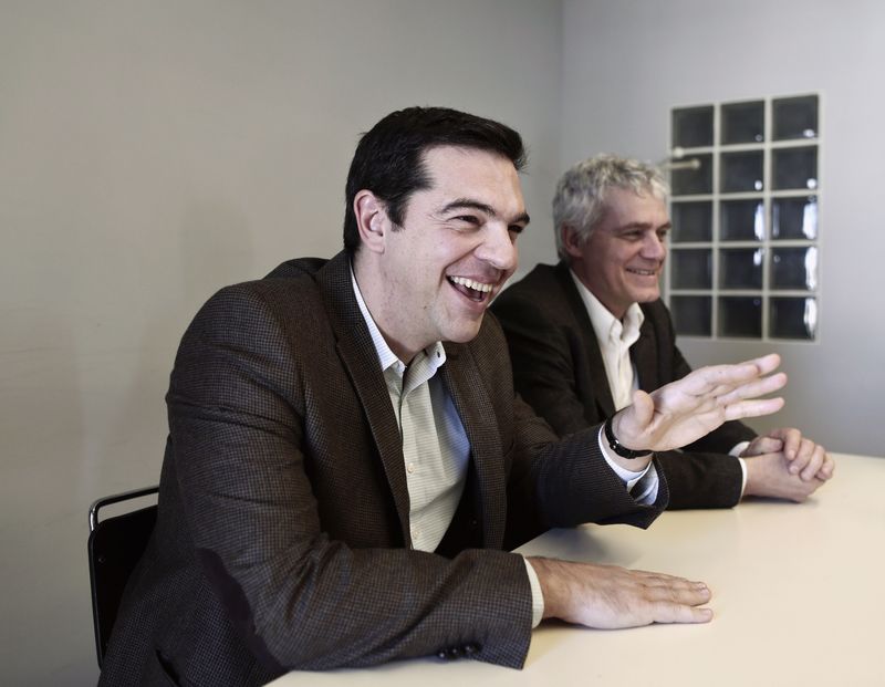 © Reuters. Tsipras, opposition leader and head of radical leftist Syriza party, smiles during a meeting with members of the Greens-Ecologists party, at the party's headquarters in Athens