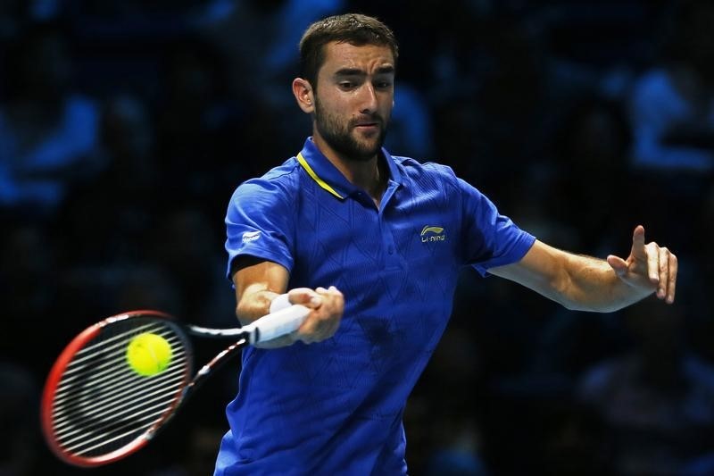 © Reuters. Cilic of Croatia returns the ball during his men's singles tennis match against Wawrinka of Switzerland at the ATP World Tour Finals at the O2 Arena in London