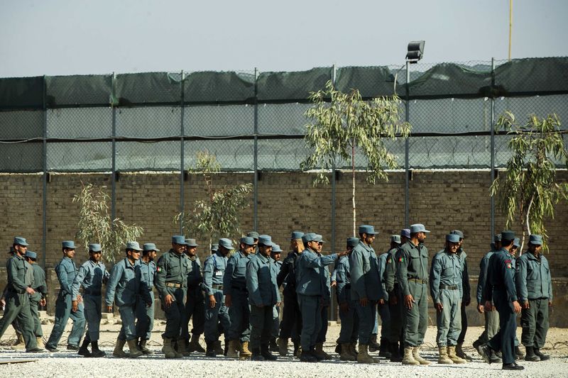 © Reuters. Afghan National police officers stand in formation during a visit by U.S. Brigadier General Christopher Bentley to an Afghan National police installation in the Nangarhar province of Afghanistan