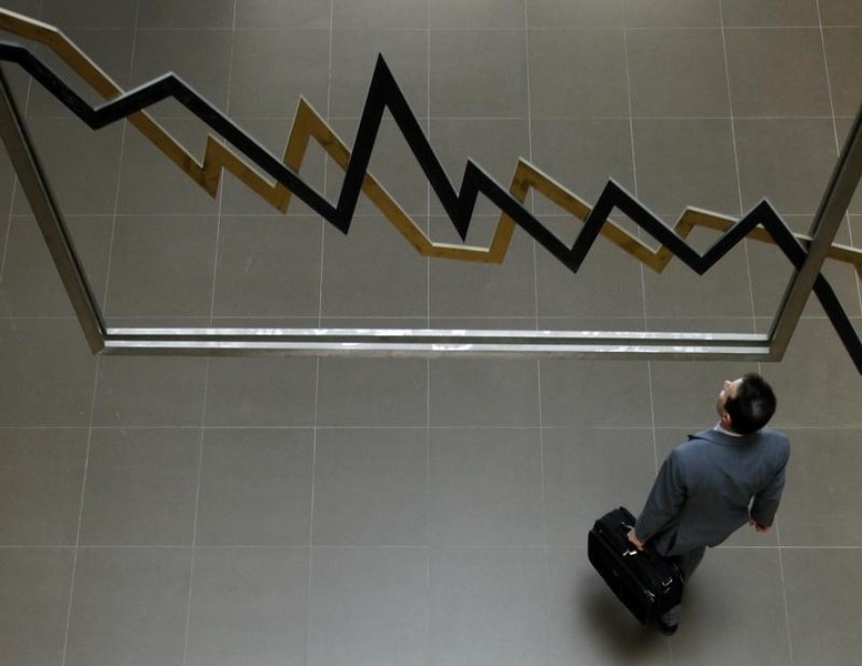 © Reuters. A man walks inside the Athens' stock exchange in Athens