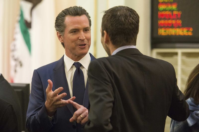 © Reuters. California Lt. Governor Gavin Newsom talks to lawmakers before Gov. Jerry Brown's inauguration at the State Capitol in Sacramento