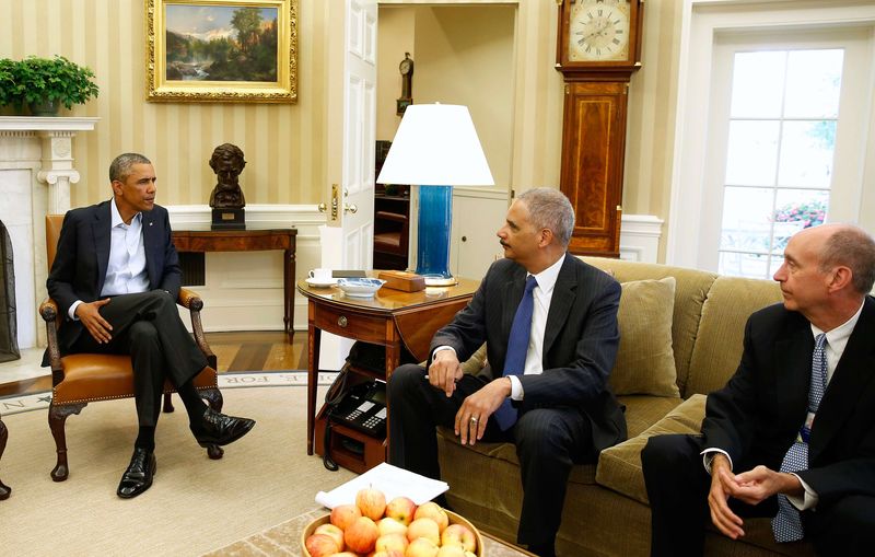 © Reuters. U.S. President Obama talks with U.S. Attorney General Holder about situation in Ferguson, Missouri, in White House in Washington in this file photo