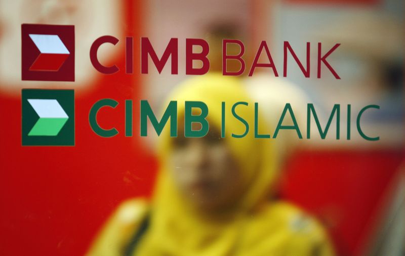 © Reuters. File photo of a customer leaving a branch of Malaysia's CIMB Bank in Kuala Lumpur