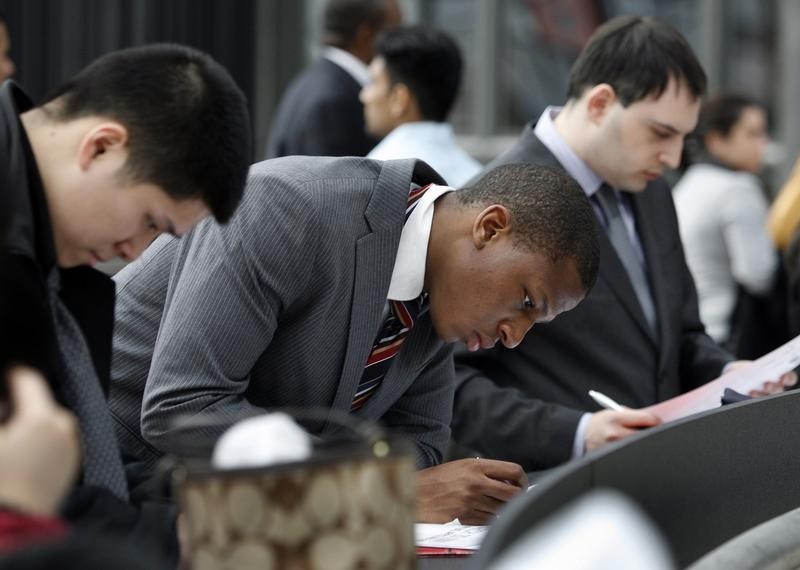 © Reuters. A man looks at a list of employers at the 2009 CUNY Big Apple Job Fair at the Jacob K. Javits Convention Center in New York