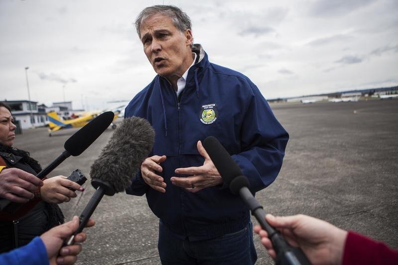 © Reuters. Washington Governor Inslee talks to reporters about ongoing recovery operations for the Oso mudslide, at the Arlington Municipal Airport in Arlington