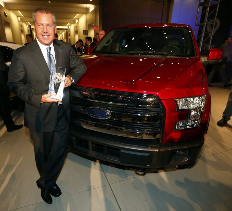 © Reuters. Ford's Hinrichs holds the North American International Autoshow Truck of the Year award given to the F-150 pickup during the press days of the North American International Auto Show in Detroit