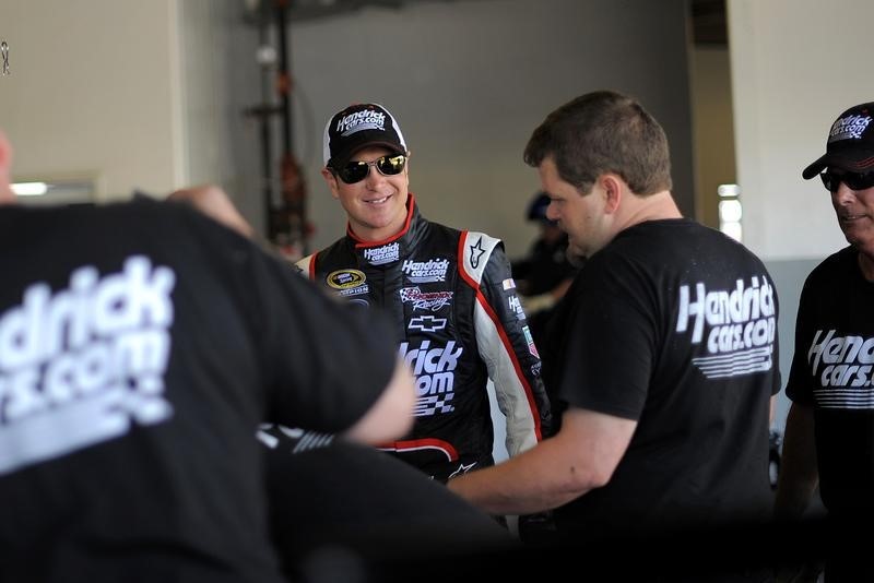 © Reuters. NASCAR Sprint Cup Series driver Kurt Busch speaks to members of his crew next to his number 51 car in the garage area in Daytona Beach