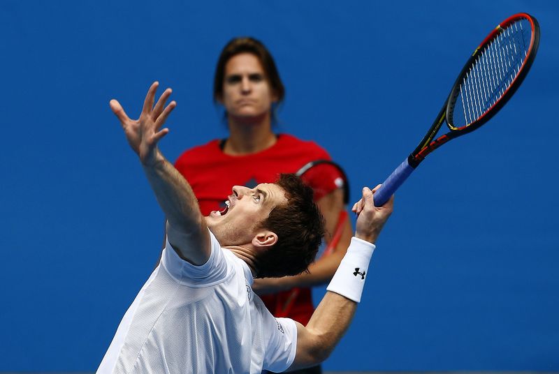 © Reuters. Amelie Mauresmo, coach of Britain's Andy Murray, watches him serve during a practice session on Hisense Arena at Melbourne Park