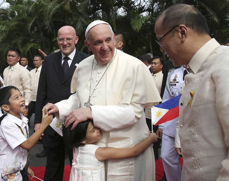 © Reuters. Papa Francisco recebe abraço de menina após cerimônia no palácio Malacanang em Manila