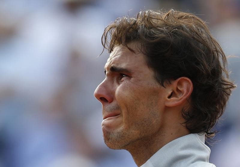 © Reuters. Rafael Nadal of Spain cries as he attends the trophy ceremony after defeating Novak Djokovic of Serbia during their men's singles final match to win the French Open Tennis tournament in Paris