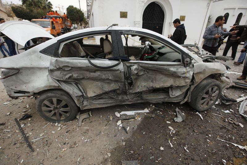 © Reuters. A damaged vehicle is seen at the scene of an explosion outside the Algerian embassy in Tripoli