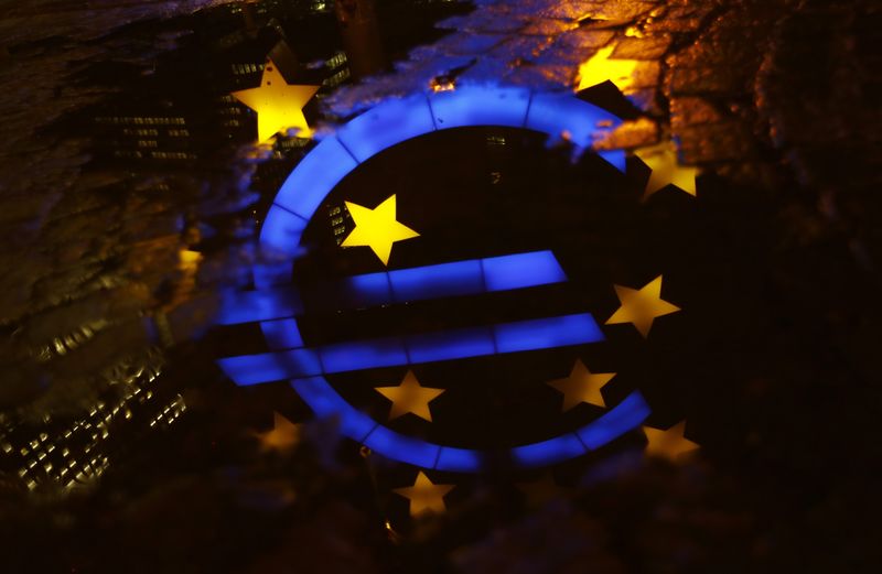 © Reuters. The famous euro sign landmark is reflected in a puddle outside the former headquarters of the European Central Bank (ECB) in Frankfurt