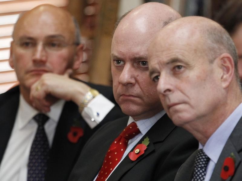 © Reuters. The head of Britain's Security  Service, MI5, Jonathan Evans, listens to Home Secretary Theresa May speak at the Royal United Services Institute in London