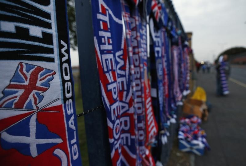 © Reuters. Scarves and flags are seen for sale outside Ibrox Stadium before the Rangers versus Inverness Caledonian Thistle soccer match in Glasgow