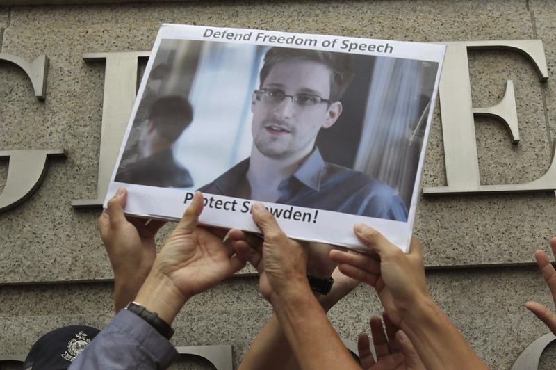 © Reuters. Protesters supporting Snowden hold a photo of him during a demonstration outside the U.S. Consulate in Hong Kong