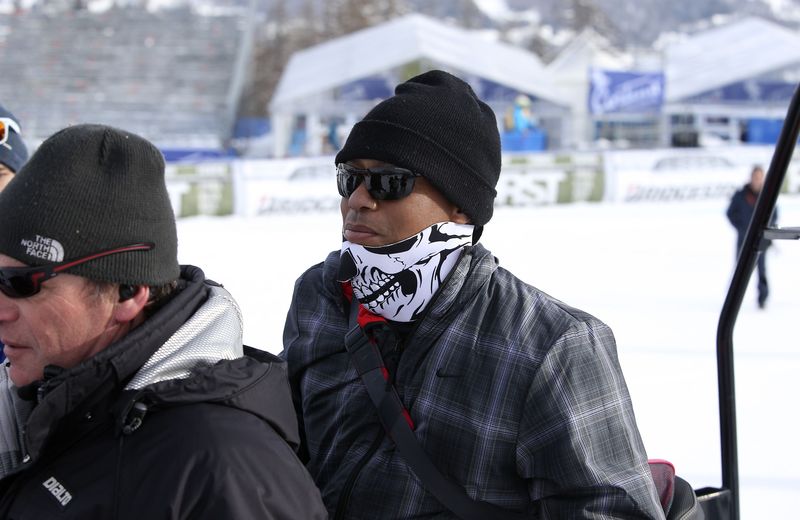 © Reuters. U.S. golfer Woods sits on a snow bike during the women's World Cup Super-G skiing race in Cortina D'Ampezzo